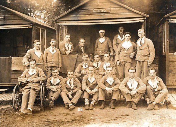 Soldiers posed in front of huts