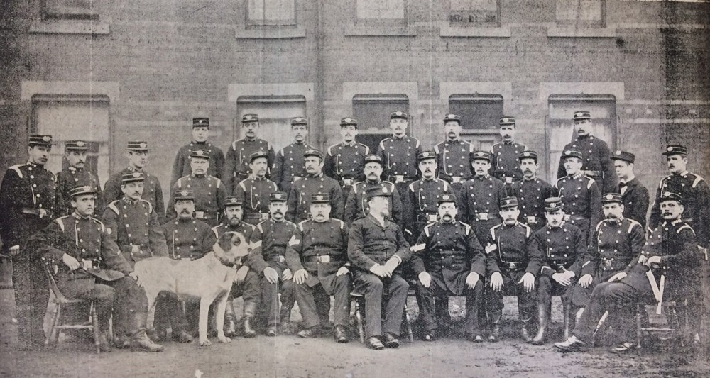 Photograph of the Leeds Corporation Fire Brigade with Baker in centre and Barney the fire dog.