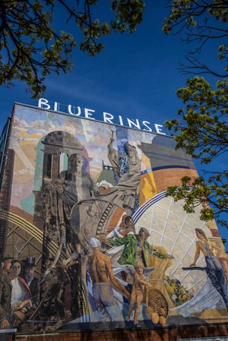 Colourful mural on the end of a row of shops in Leeds city centre