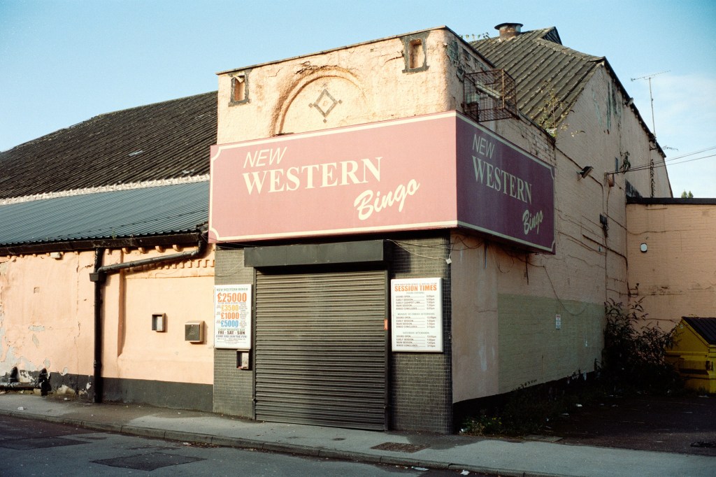 Colour photo of a closed bingo hall with shutters down.