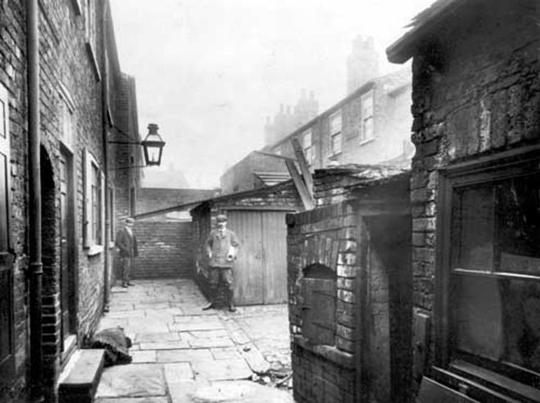 Photograph of an 'unhealthy area' with two local residents